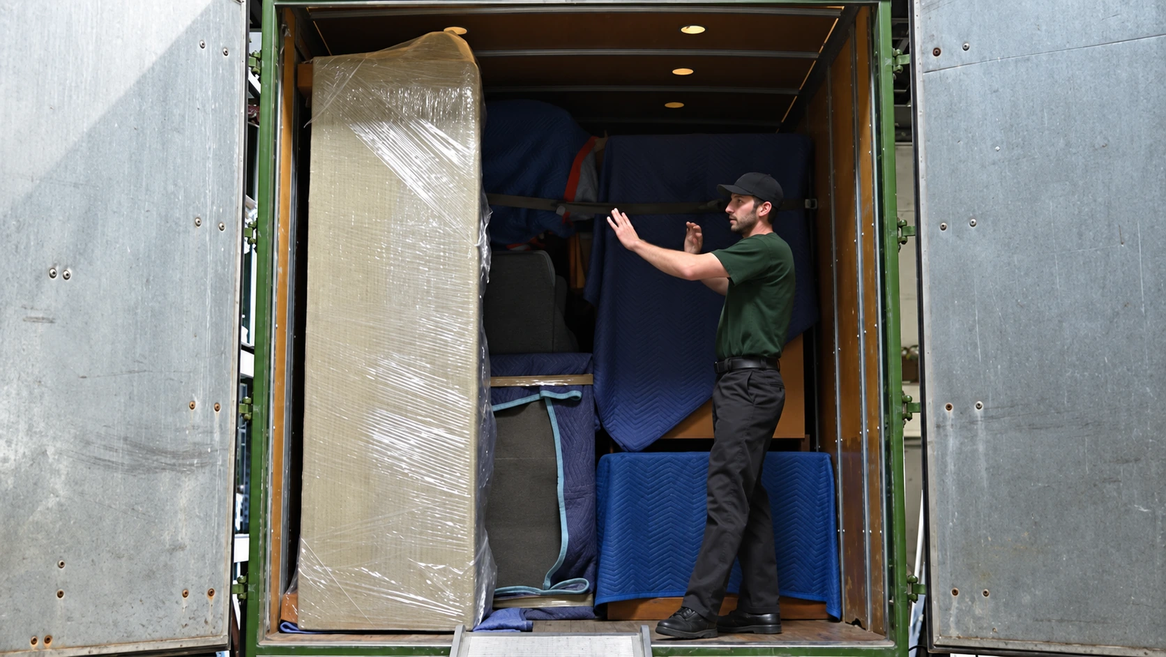 Movers unloading protected furniture near Bristol
