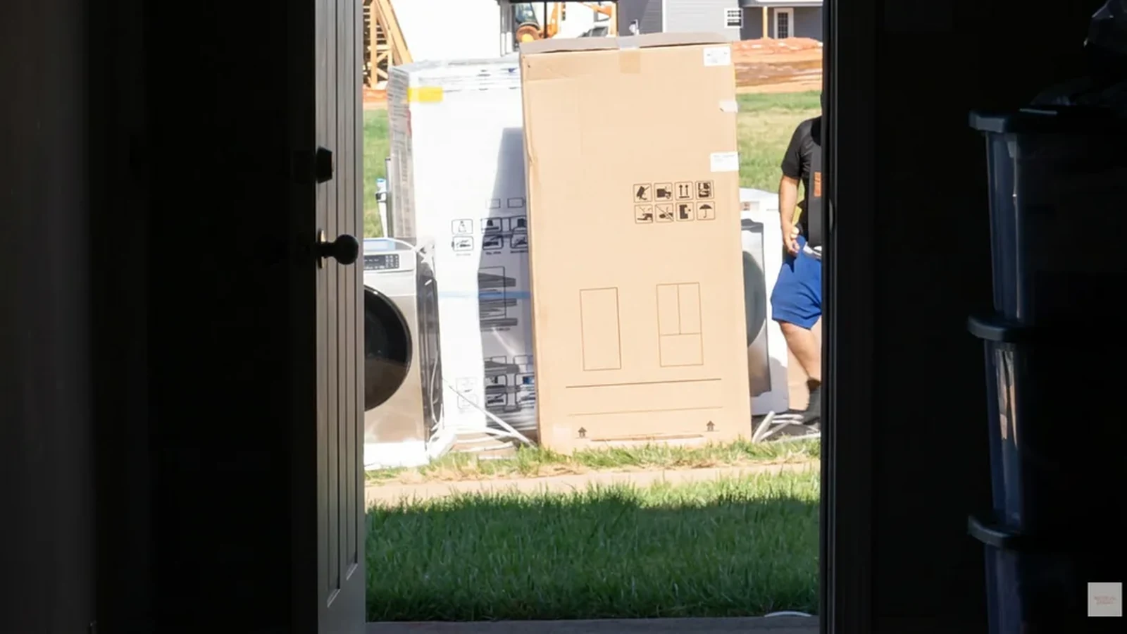 Movers carrying wrapped furniture during a residential move